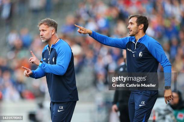 Lars Vossler, Assistant Coach of SC Freiburg, and Julian Schuster, Coach of SC Freiburg, react during the Bundesliga match between Hertha BSC and...