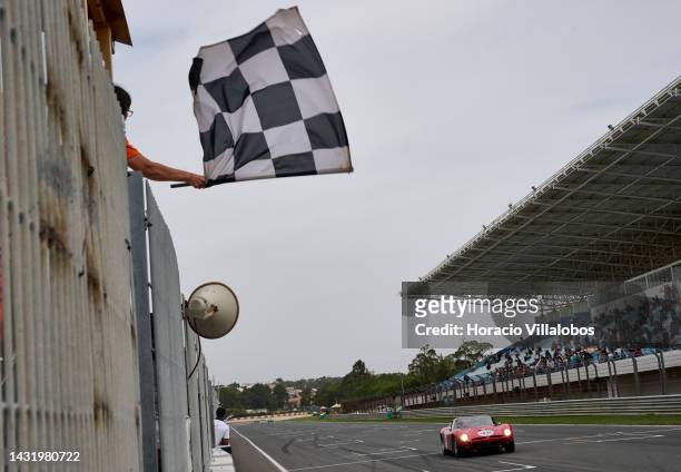 Christian Bouriez gets the checkered flag while winning with his Bizzarrini 5300 GT Strada The Greatest's Trophy race on the last day of Estoril...