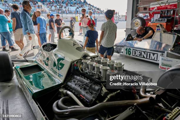 Spectators pose for pictures by a Williams F-1 race car in the pits area during the last day of Estoril Classics in Fernanda Pires da Silva Estoril...