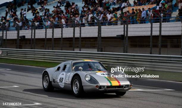 Spectators watch a car speeding by during The Greatest's Trophy race on the last day of Estoril Classics in Fernanda Pires da Silva Estoril Circuit...