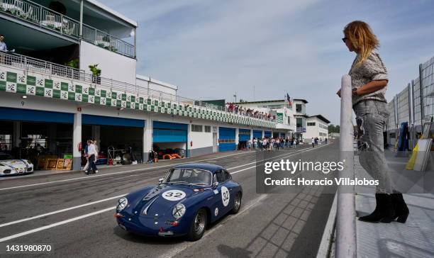 Woman watches a car entering pits area during The Greatest's Trophy race on the last day of Estoril Classics in Fernanda Pires da Silva Estoril...