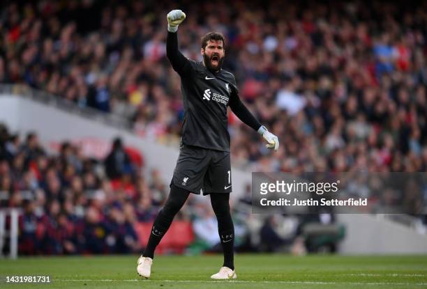 Alisson Becker celebrates after Darwin Nunez of Liverpool scored their sides first goal during the Premier League match between Arsenal FC and...