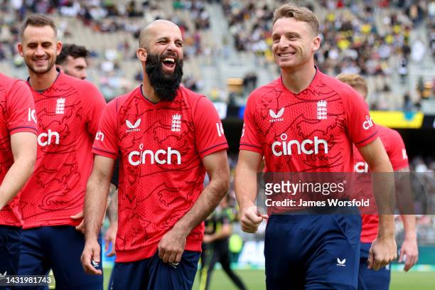 Mooed Ali and Jos Buttler of England share a laugh as they walk out or the national anthem during game one of the T20 International series between...