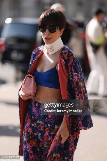 Fashion week guest seen wearing a colourful chanel look, outside Chanel during Paris Fashion Week on October 04, 2022 in Paris, France.