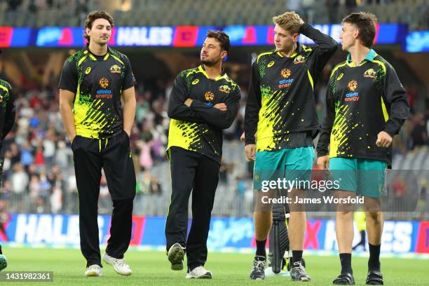 Tim David, Marcus Stoinis, Cameron Green and Mitch Marsh of Australia walk off the ground after their loss during game one of the T20 International...