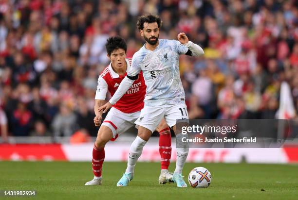 Mohamed Salah of Liverpool is challenged by Takehiro Tomiyasu of Arsenal during the Premier League match between Arsenal FC and Liverpool FC at...
