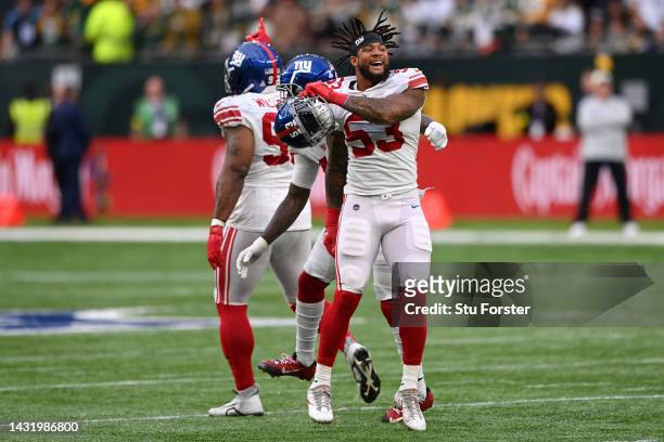 Oshane Ximines of the New York Giants celebrates a sack on Aaron Rodgers of the Green Bay Packers in the fourth quarter to win the game during the...