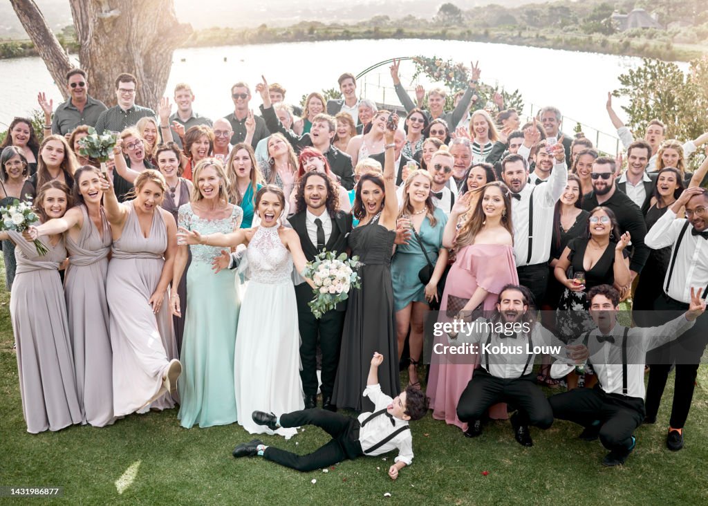 Wedding portrait and bridal party celebrate happy day of love and commitment together with joy. Married couple pose for excited and cheerful ceremony people photograph with friends and family.