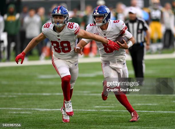 Daniel Jones rushes the ball with protection from Tanner Hudson of the New York Giants in the fourth quarter during the NFL match between New York...