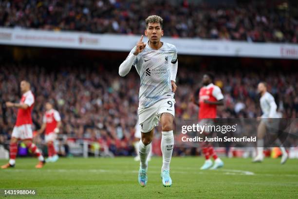 Roberto Firmino of Liverpool celebrates after scoring their team's second goal during the Premier League match between Arsenal FC and Liverpool FC at...