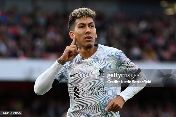 Roberto Firmino of Liverpool celebrates after scoring their team's second goal during the Premier League match between Arsenal FC and Liverpool FC at...