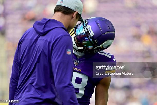 Justin Jefferson of the Minnesota Vikings jokes with head coach Kevin O'Connell before the game against the Chicago Bears at U.S. Bank Stadium on...