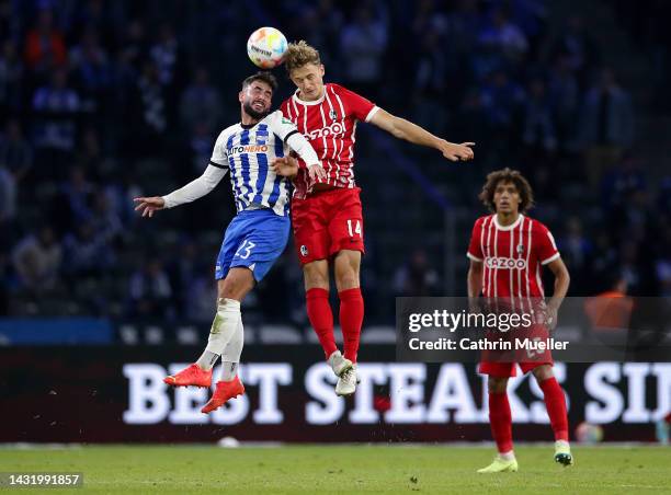 Marco Richter of Hertha BSC contends for the aerial ball with Yannik Keitel of SC Freiburg during the Bundesliga match between Hertha BSC and...