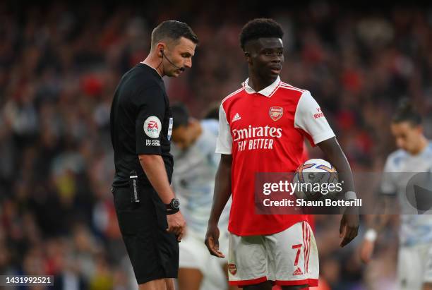 Bukayo Saka of Arsenal looks on before taking a penalty during the Premier League match between Arsenal FC and Liverpool FC at Emirates Stadium on...