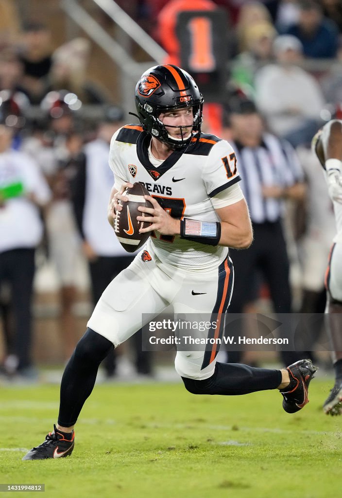 Ben Gulbranson of the Oregon State Beavers rolls out to pass against ...