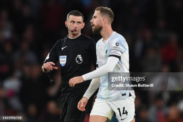 Jordan Henderson of Liverpool speaks to Referee Michael Oliver during the Premier League match between Arsenal FC and Liverpool FC at Emirates...