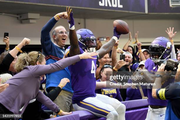 Dalvin Cook of the Minnesota Vikings celebrates a touchdown rush with fans against the Chicago Bears at U.S. Bank Stadium on October 09, 2022 in...