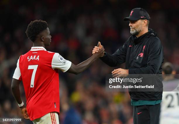 Bukayo Saka of Arsenal shakes hands with Juergen Klopp, Manager of Liverpool after the final whistle of the Premier League match between Arsenal FC...