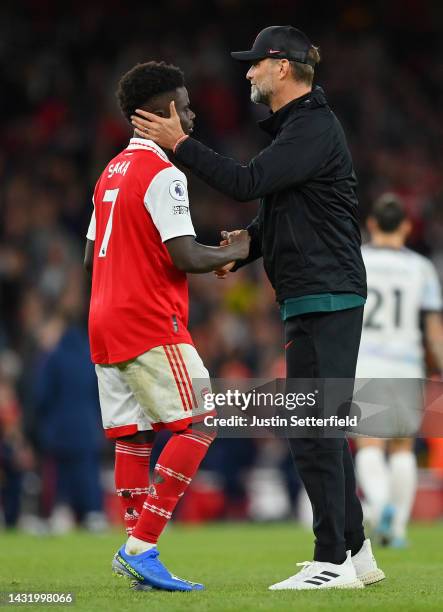 Bukayo Saka of Arsenal shakes hands with Juergen Klopp, Manager of Liverpool after the final whistle of the Premier League match between Arsenal FC...