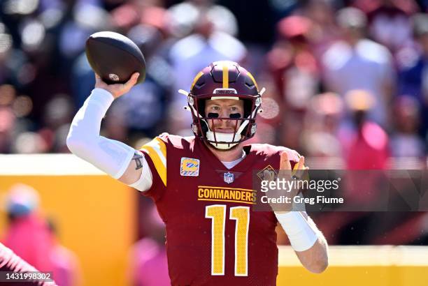 Carson Wentz of the Washington Commanders attempts a pass during the first quarter against the Tennessee Titans at FedExField on October 09, 2022 in...