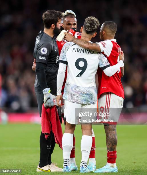 Alisson Becker and Roberto Firminho of Liverpool discuss game with Brazilian team-mates Gabriel Jesus and Gabriel of Arsenal after Arsenals 3-2 win...