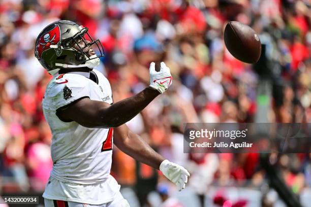 Leonard Fournette of the Tampa Bay Buccaneers throws the football to fans after a touchdown in the second quarter of the game against the Atlanta...