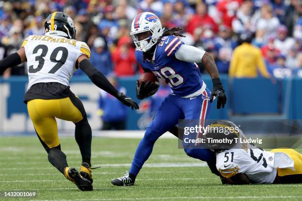 James Cook of the Buffalo Bills is tackled by Myles Jack of the Pittsburgh Steelers during the second quarter at Highmark Stadium on October 09, 2022...