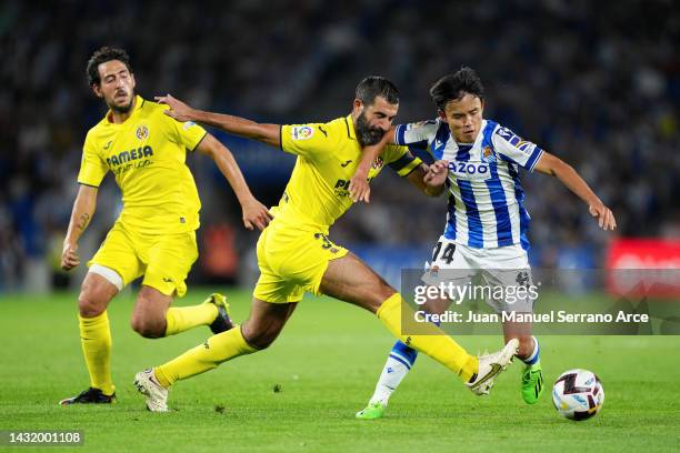 Raul Albiol of Villarreal CF challenges Takefusa Kubo of Real Sociedad during the LaLiga Santander match between Real Sociedad and Villarreal CF at...