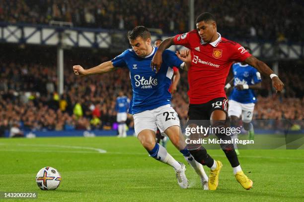 Seamus Coleman of Everton battles for possession with Marcus Rashford of Manchester United during the Premier League match between Everton FC and...