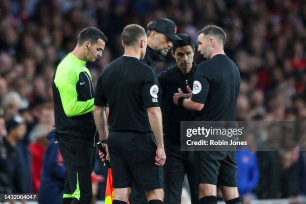 Head Coachs' Jurgen Klopp of Liverpool and Mikel Arteta of Arsenal are called together by Referee Michael Oliver during the Premier League match...