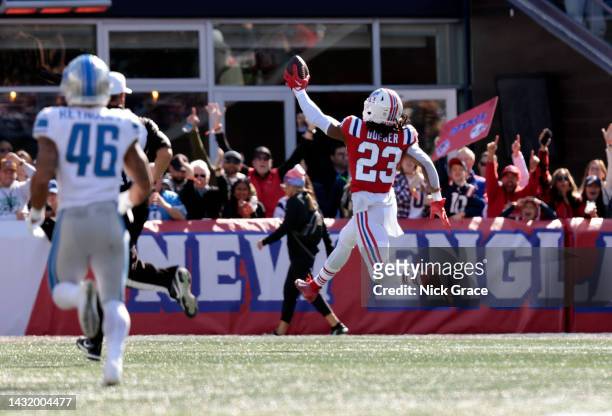 Kyle Dugger of the New England Patriots celebrates after returning a fumble for a touchdown during the second quarter against the Detroit Lions at...