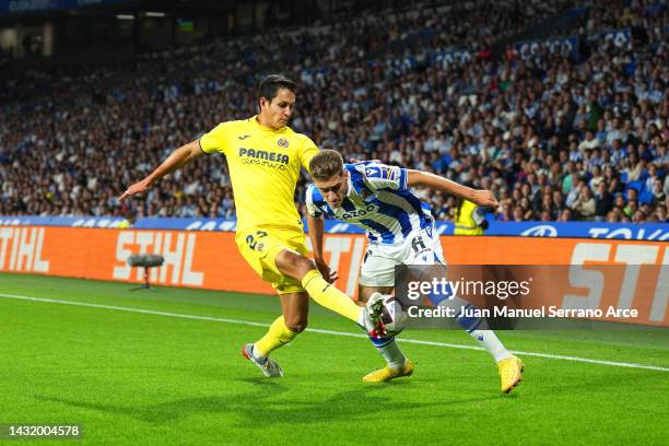 Aissa Mandi of Villarreal battles for possession with Robert Navarro of Real Sociedad during the LaLiga Santander match between Real Sociedad and...