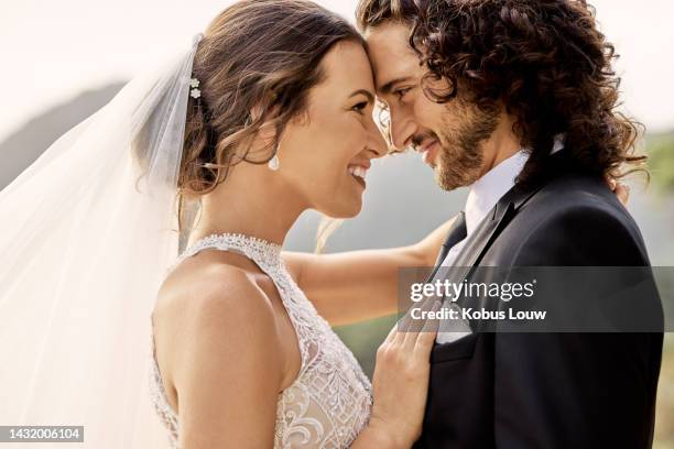 love, romance and wedding with bride and groom embracing and sharing an intimate and romantic moment. happy, smile and celebration with excited couple celebrating marriage at an elegant ceremony - couple jewelry stockfoto's en -beelden