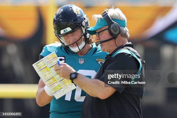 Head coach Doug Pederson of the Jacksonville Jaguars discusses a play with Trevor Lawrence during the first half of the game against the Houston...