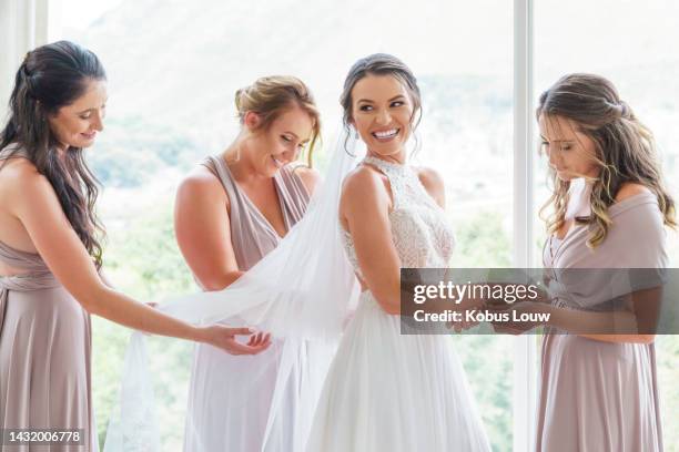 wedding, bride and bridesmaids with a woman and her friends getting ready for a marriage ceremony or celebration event. love, romance and tradition with a young female and her friend group inside - bruidsmeisje stockfoto's en -beelden