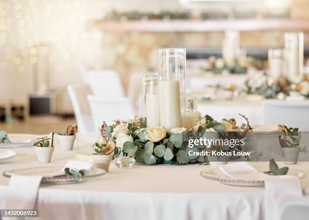 wedding reception, table setting and celebration event with flower arrangement, decor and catering for a romantic setting. party, luxury restaurant or fancy place with cutlery and tableware - table decoration stockfoto's en -beelden