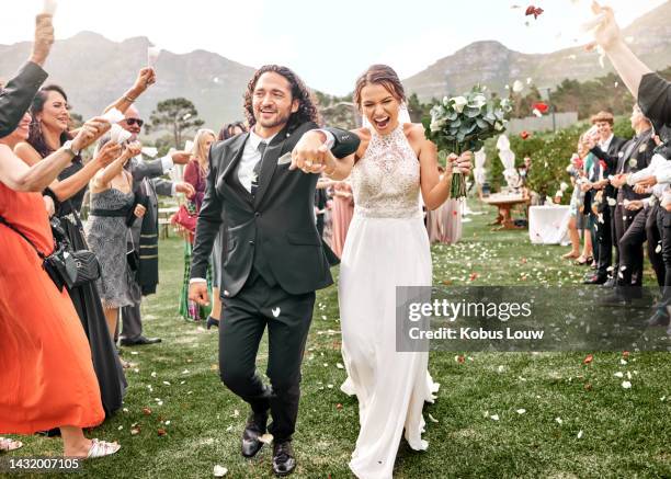 couple holding hands, wedding celebration and nature event in summer with family, happy at marriage reception in mountains and smile for love. man and bride walking in aisle with friends to celebrate - wedding ceremony stock pictures, royalty-free photos & images