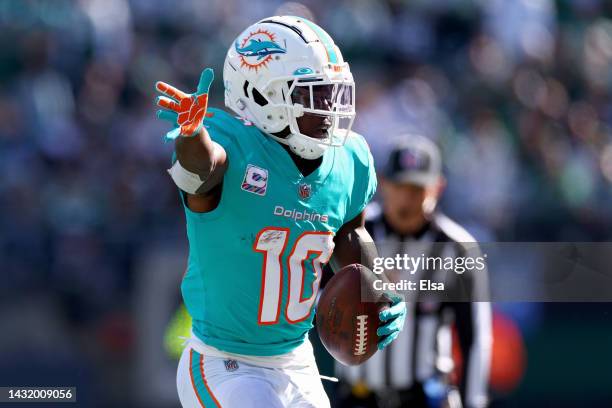 Tyreek Hill of the Miami Dolphins celebrates a first down New York Jets during the second quarter at MetLife Stadium on October 09, 2022 in East...