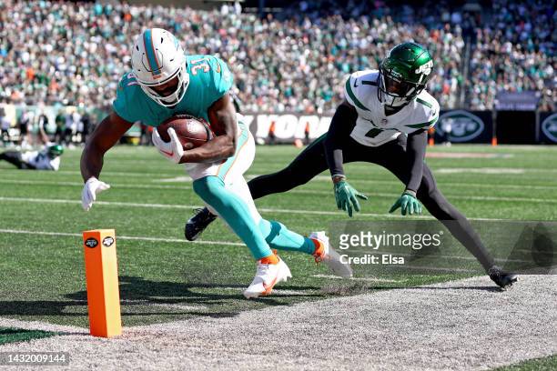 Raheem Mostert of the Miami Dolphins steps out of bounds short of the goal line as Sauce Gardner of the New York Jets defends during the second...