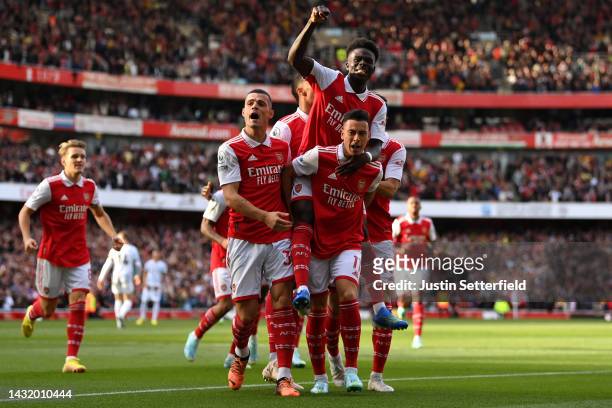Gabriel Martinelli of Arsenal celebrates with teammates after scoring their team's first goal during the Premier League match between Arsenal FC and...