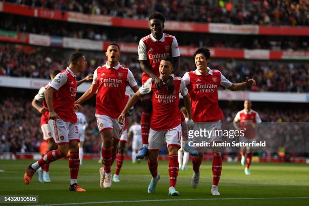 Gabriel Martinelli of Arsenal celebrates with teammates after scoring their team's first goal during the Premier League match between Arsenal FC and...