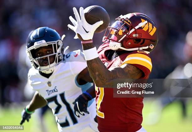 Dyami Brown of the Washington Commanders catches a touchdown over Roger McCreary of the Tennessee Titans during the third quarter at FedExField on...