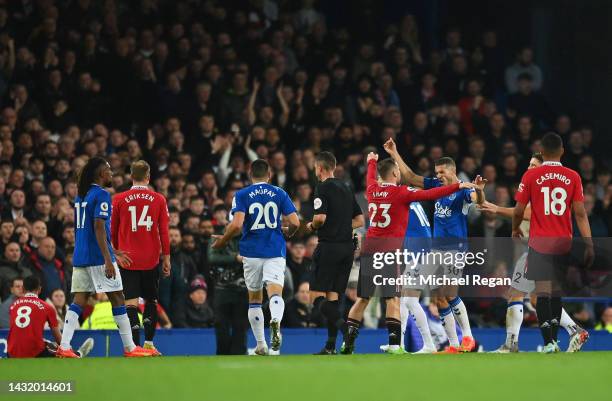 Luke Shaw of Manchester United clashes with Conor Coady of Everton during the Premier League match between Everton FC and Manchester United at...