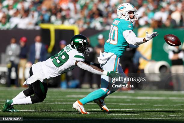 Tanner Conner of the Miami Dolphins is unable to make the catch as Will Parks of the New York Jets defends during the second half at MetLife Stadium...