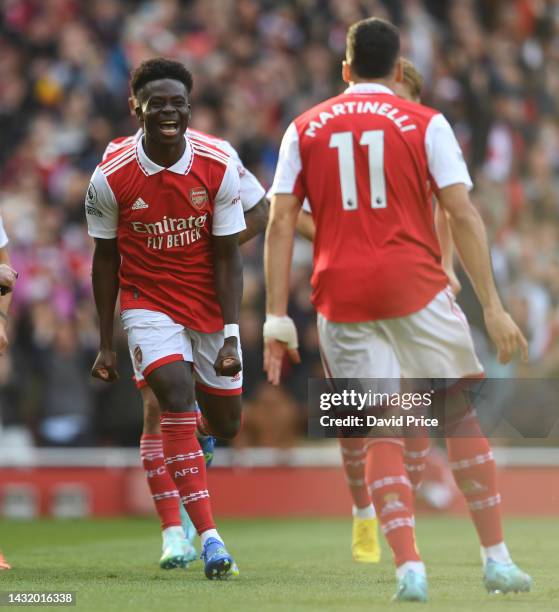 Bukayo Saka celebrates the 1st Arsenal goal scored by Gabriel Martinelli during the Premier League match between Arsenal FC and Liverpool FC at...