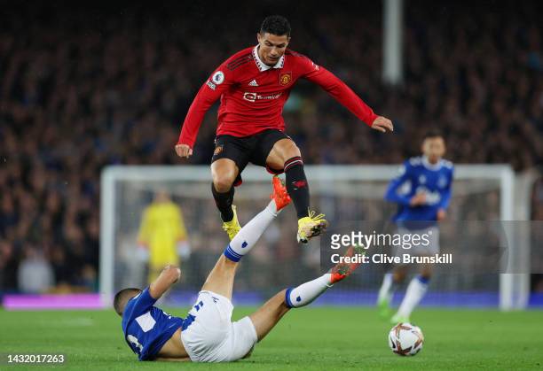 Cristiano Ronaldo of Manchester United is challenged by Conor Coady of Everton during the Premier League match between Everton FC and Manchester...