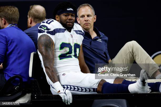 Rashaad Penny of the Seattle Seahawks is carted off the field after being injured during the third quarter against the New Orleans Saints at Caesars...