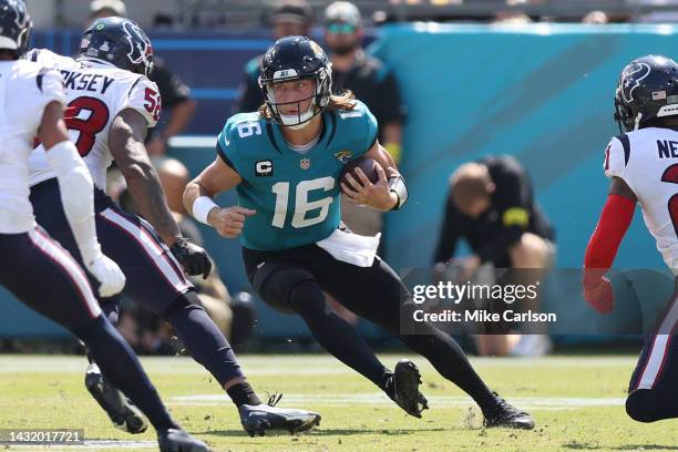 Trevor Lawrence of the Jacksonville Jaguars runs the ball against Christian Kirksey of the Houston Texans during the second half at TIAA Bank Field...