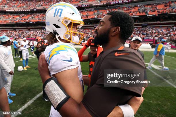 Justin Herbert of the Los Angeles Chargers and Jacoby Brissett of the Cleveland Browns hug after Los Angeles' 30-28 win at FirstEnergy Stadium on...