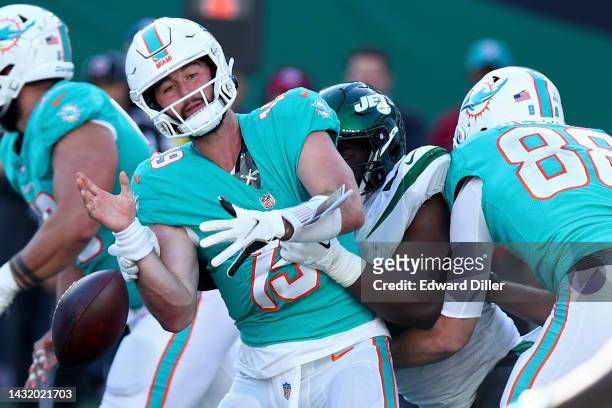 Carl Lawson of the New York Jets forces a fumble against Skylar Thompson of the Miami Dolphins during the second hal at MetLife Stadium on October...